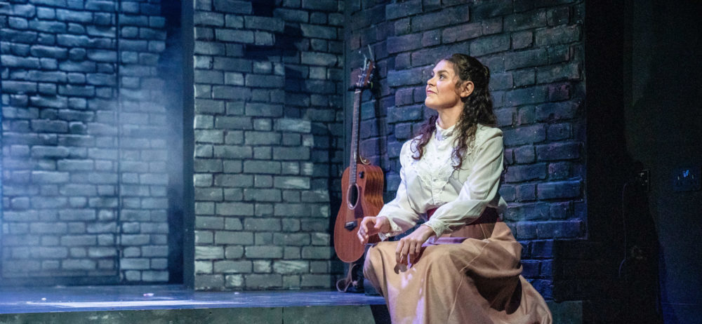 woman sat on the stage at the barn theatre